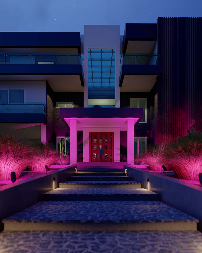Modern home exterior at night with vibrant pink landscape lighting illuminating the entrance