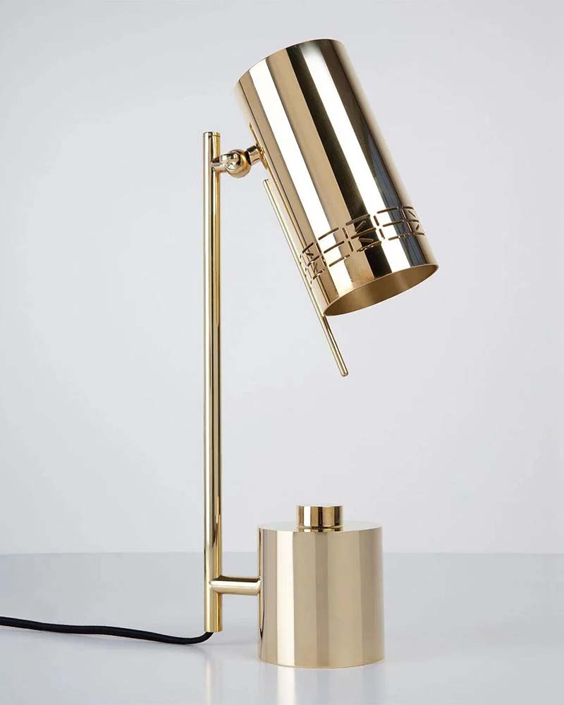 Sleek gold cylindrical desk lamp with an adjustable neck on a plain white background