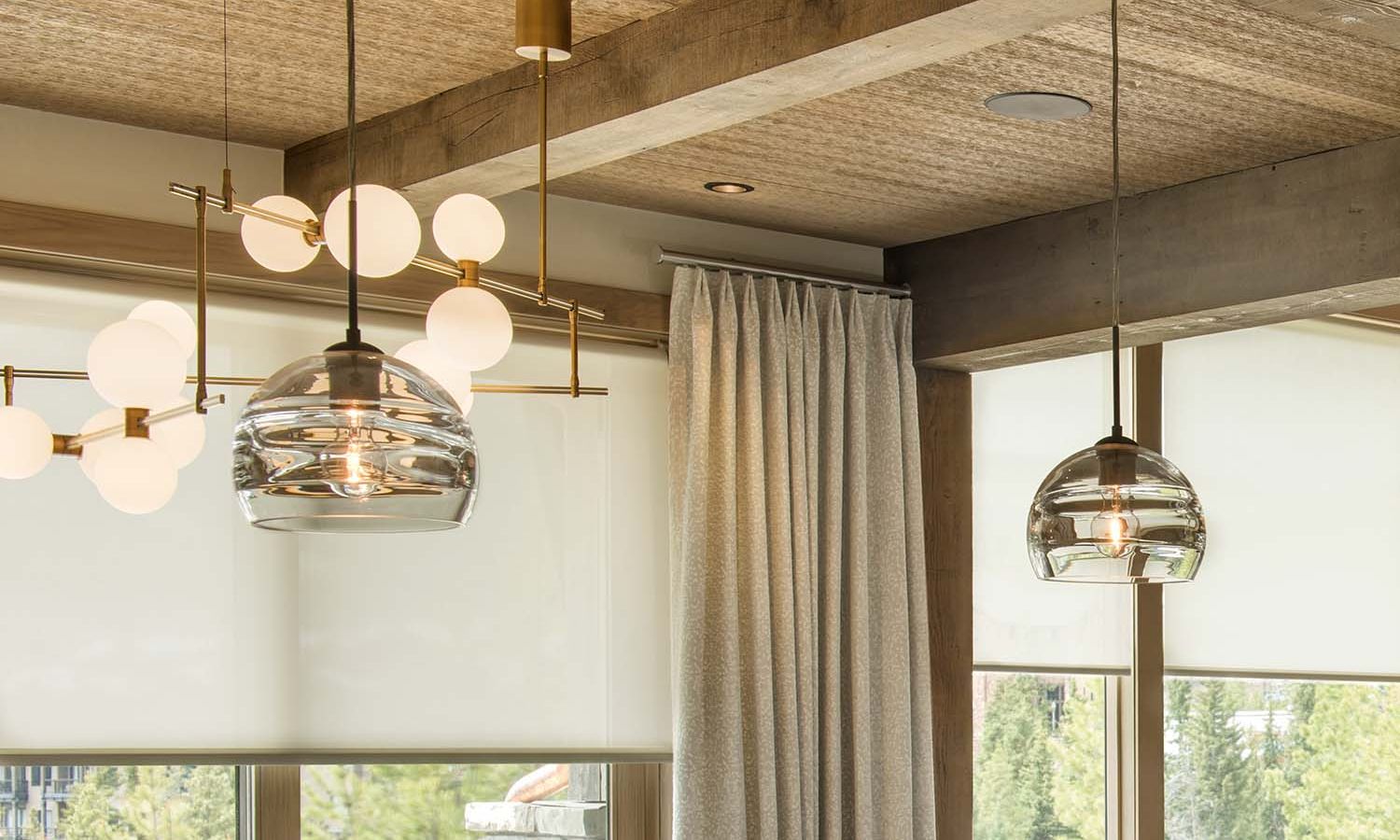 Elegant interior featuring glass pendant lights and architectural beams with recessed spotlights
